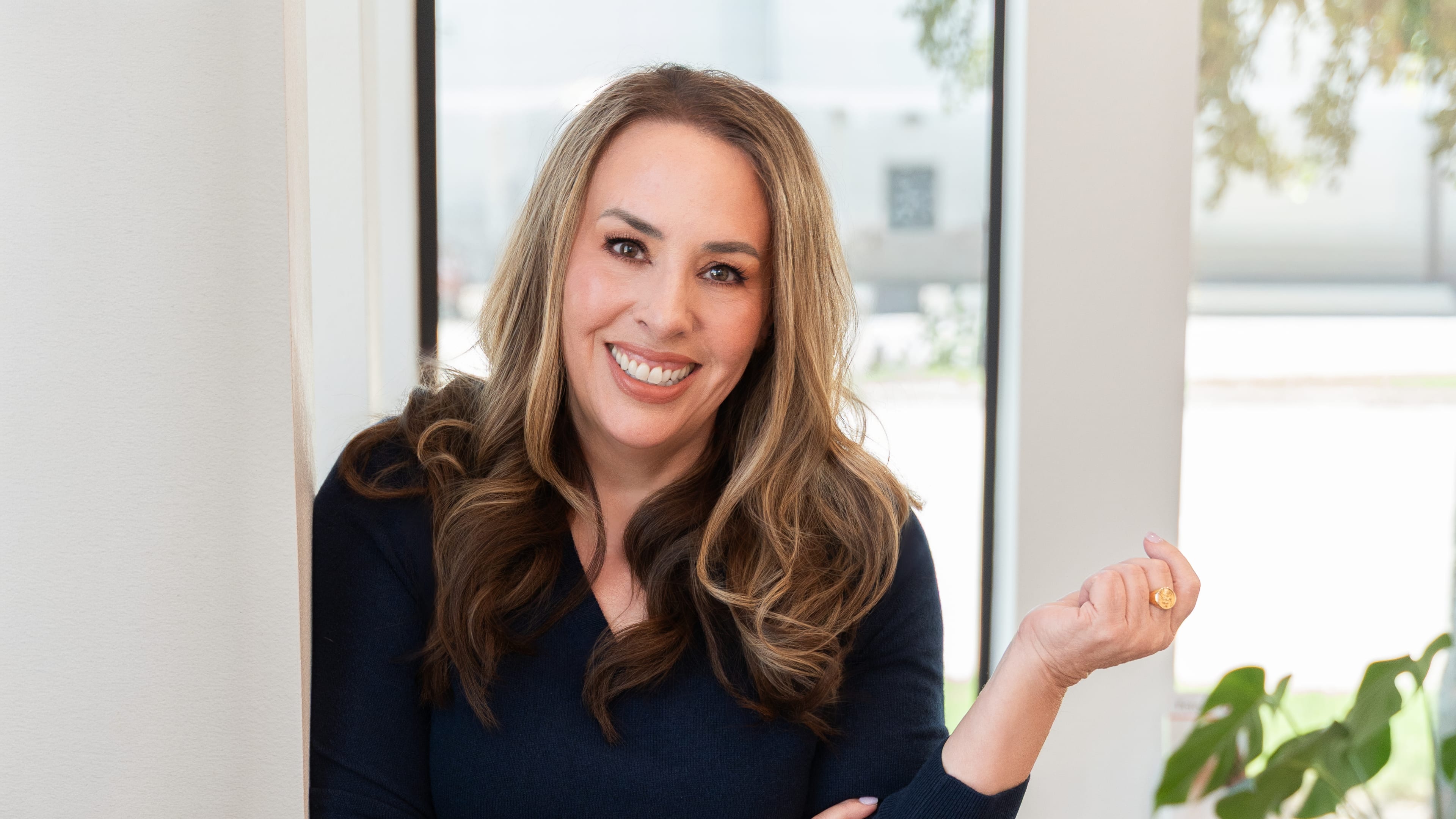 Dr. Heather Bartos smiling by a window